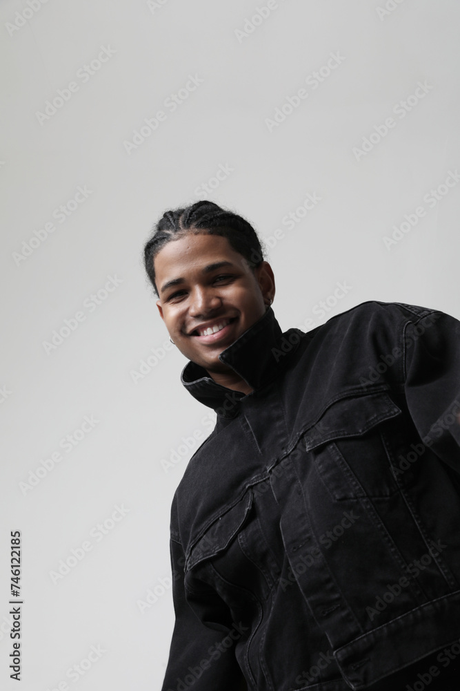 Portrait of happy and handsome dark-skinned young man posing indoor. Vertical. Portrait of happy and handsome dark-skinned young man posing indoor. Vertical.