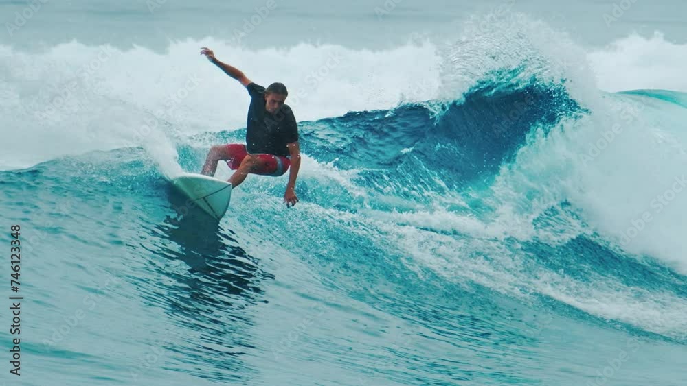 Surfer rides the ocean wave in the Maldives Surfer rides the ocean wave in the Maldives
