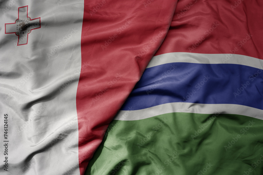 big waving national colorful flag of gambia and national flag of malta. big waving national colorful flag of gambia and national flag of malta.