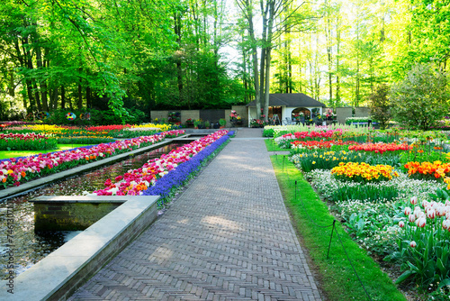 Fototapeta Naklejka Na Ścianę i Meble -  Colourful Tulips Flowerbeds and paved Path in an Spring Formal Garden