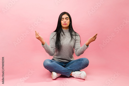 Hispanic beautiful woman meditating and relaxing