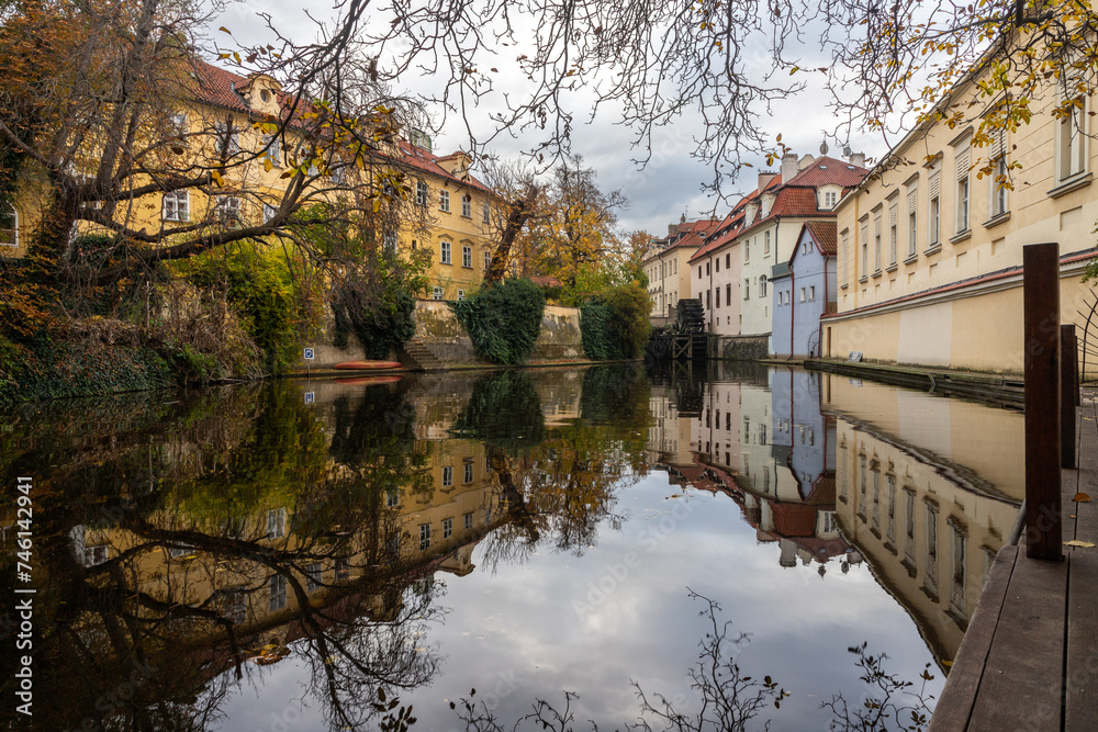 autumn reflections on the Čertovka canal under the Charles Bridge