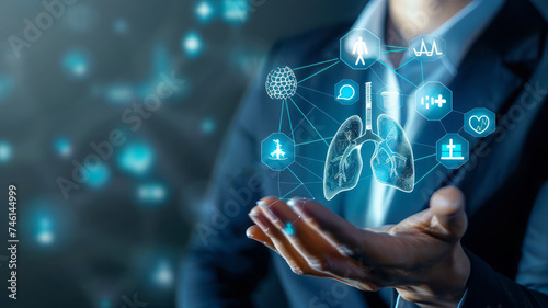 A person handles icons related to the medical network, including a lung hologram. Conceptually, this represents the synthesis of technology and medicine, with a focus on innovation and digital health  photo