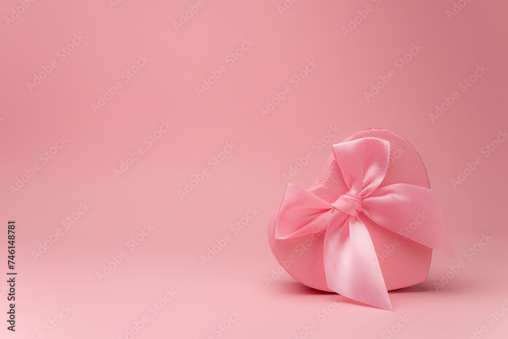 Heart Gift box with ribbon on pink surface Heart Gift box with ribbon on pink surface