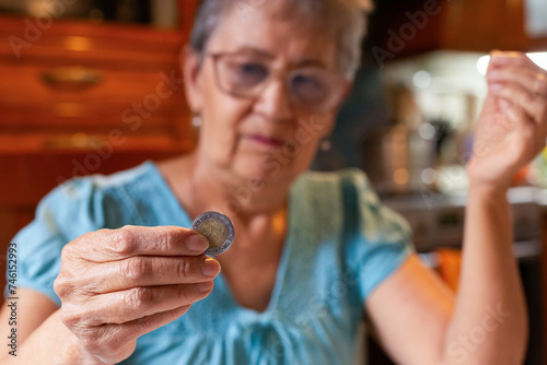 A woman gracefully holds a glimmering coin in her right hand, symbolizing power, prosperity, and good fortune.