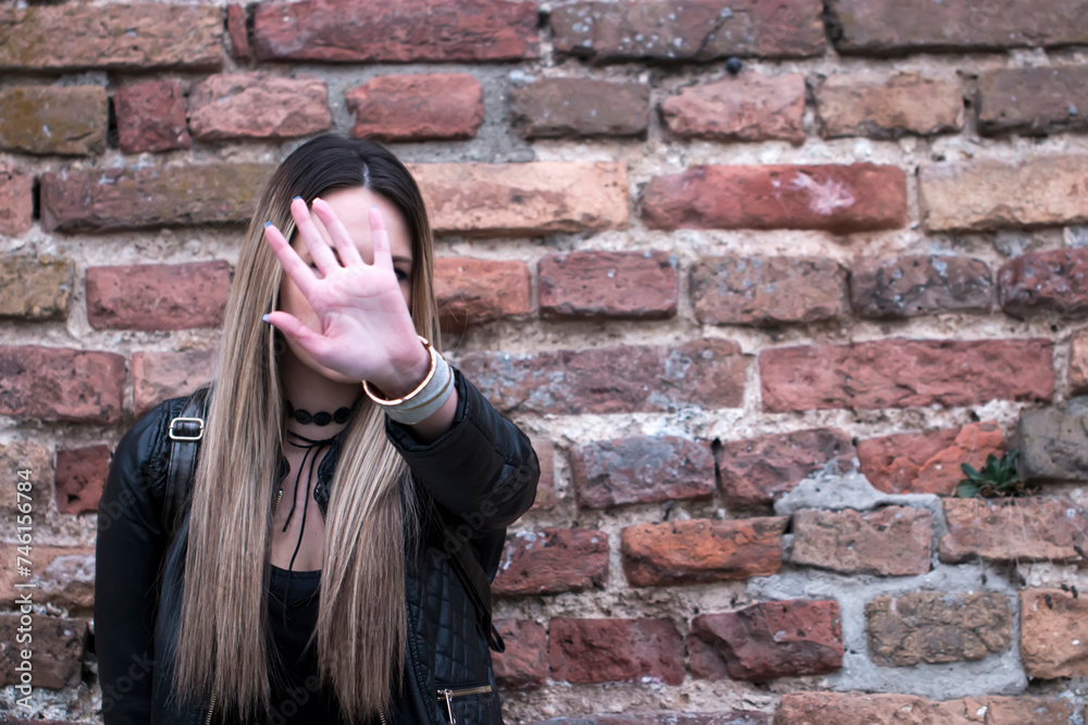 Pretty young girl making stop sign. Stop hand of woman sign of discrimination. Woman is showing stop gesture with her hand Pretty young girl making stop sign. Stop hand of woman sign of discrimination. Woman is showing stop gesture with her hand