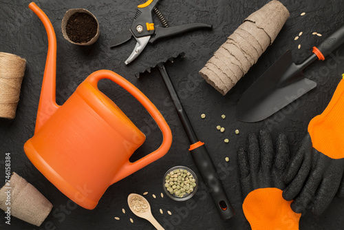 Orange gardening tools on conctere background, top view photo