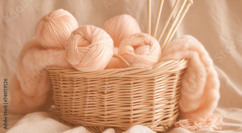 A basket of yarn balls and knitting needles with a soft knitted fabric in warm tones