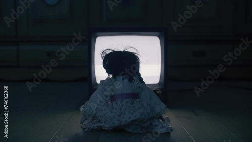 Scary old child's play watching a broken TV.