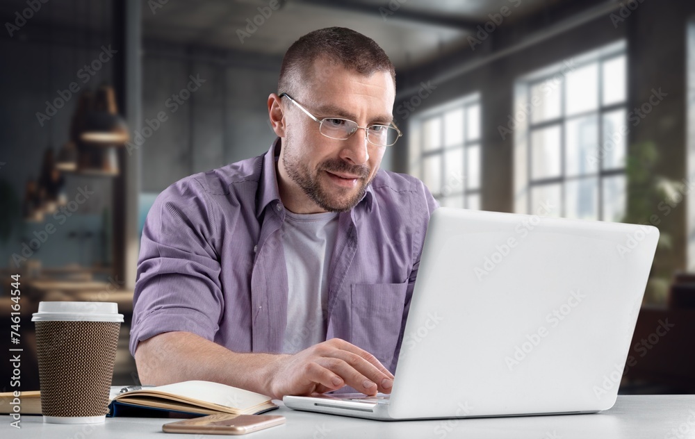 Smiling young businessman working in office Smiling young businessman working in office