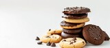 A stack of cookies with chocolate chips on top, isolated on a white background. The cookies are golden brown and freshly baked, with visible chocolate chips sprinkled generously on top.