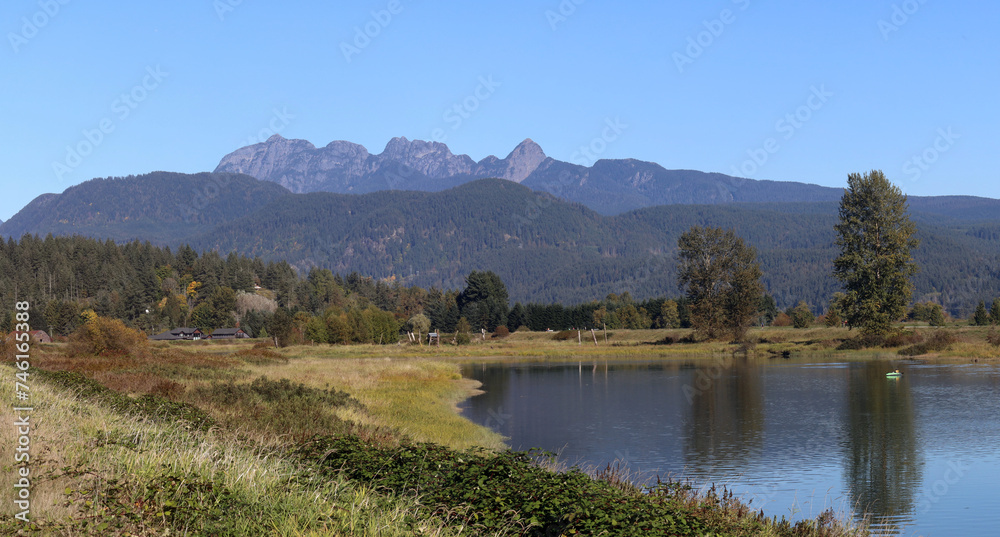 Summer idyllic scenery with river and mountains