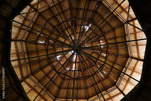 Traditional roof structure of the tribes in the Brazilian Amazon region.Indigeno us wooden structure covered with straw. Indigenous wooden structure covered with straw. Manaus, Amazonas, Brazil. photo