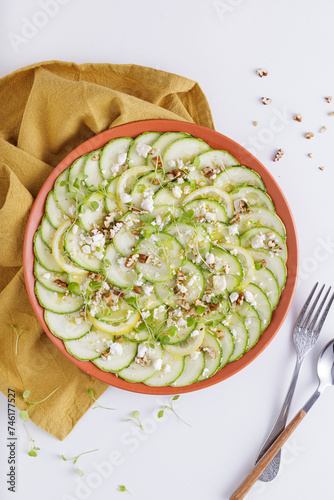 Cucumber Salad with White Cheese and Nuts Ingredients on a wooden chopping board and white background