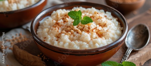 A detailed image of a bowl filled with delicious and traditional rice pudding placed on a table.