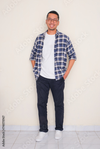 Full body portrait of a man standing and smiling at the camera photo