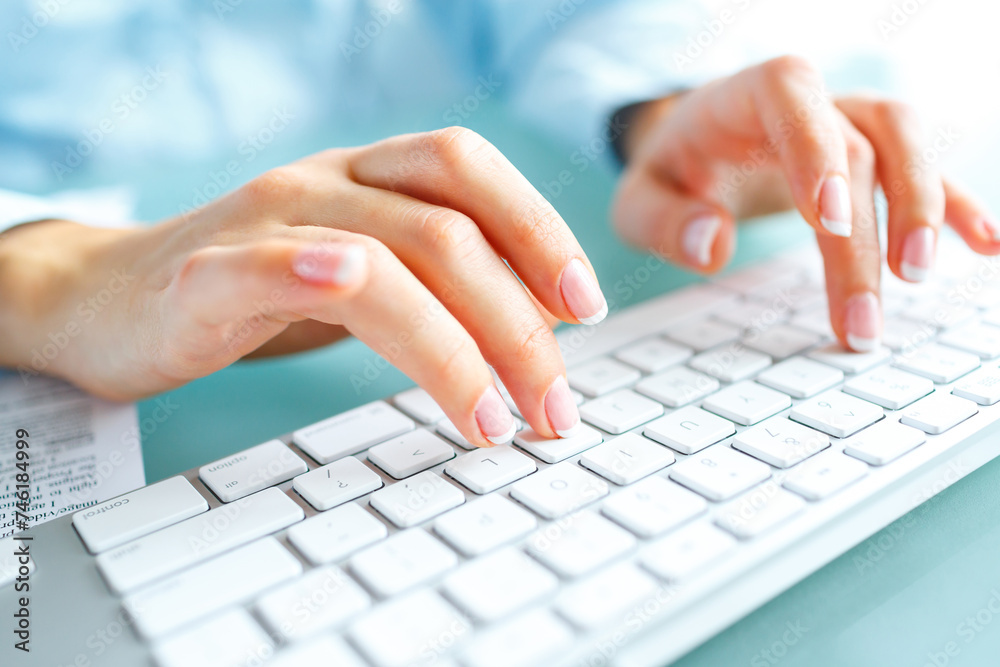 Woman office worker typing on the keyboard Woman office worker typing on the keyboard