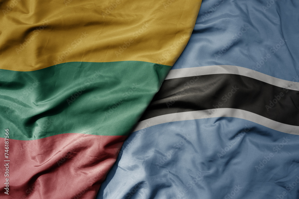 big waving national colorful flag of botswana and national flag of lithuania .