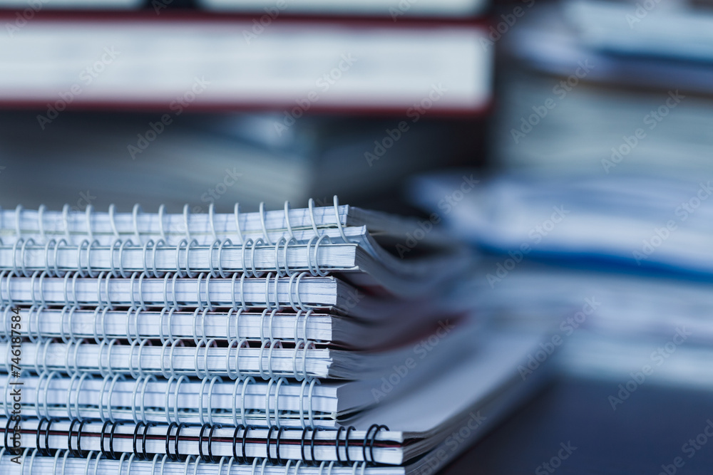 Accounting and taxes. Pile of magazine, notebook and books closeup Accounting and taxes. Pile of magazine, notebook and books closeup