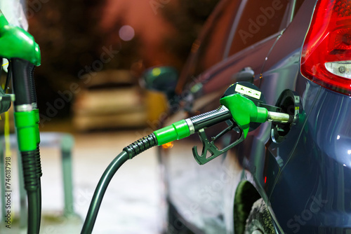 Car refueling on a petrol station in winter at night