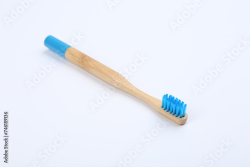 Bamboo toothbrush with blue bristle isolated on white