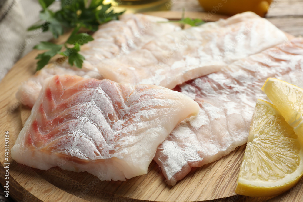 Fresh raw cod fillets on wooden table, closeup Fresh raw cod fillets on wooden table, closeup