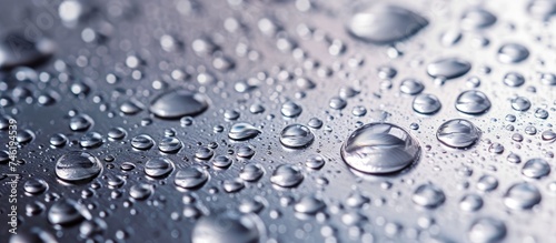 A serene display of drops of water on gleaming stainless steel, creating a captivating and stunning background.