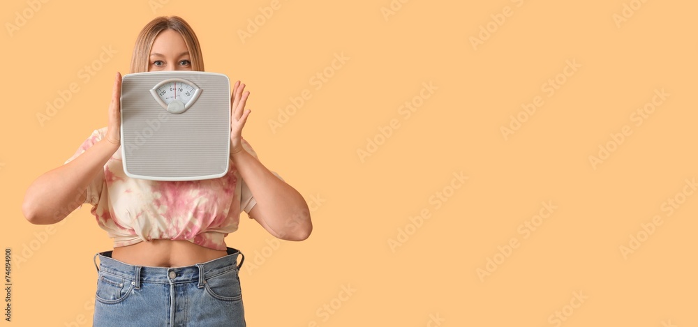 Woman holding scales on beige background with space for text. Weight loss concept