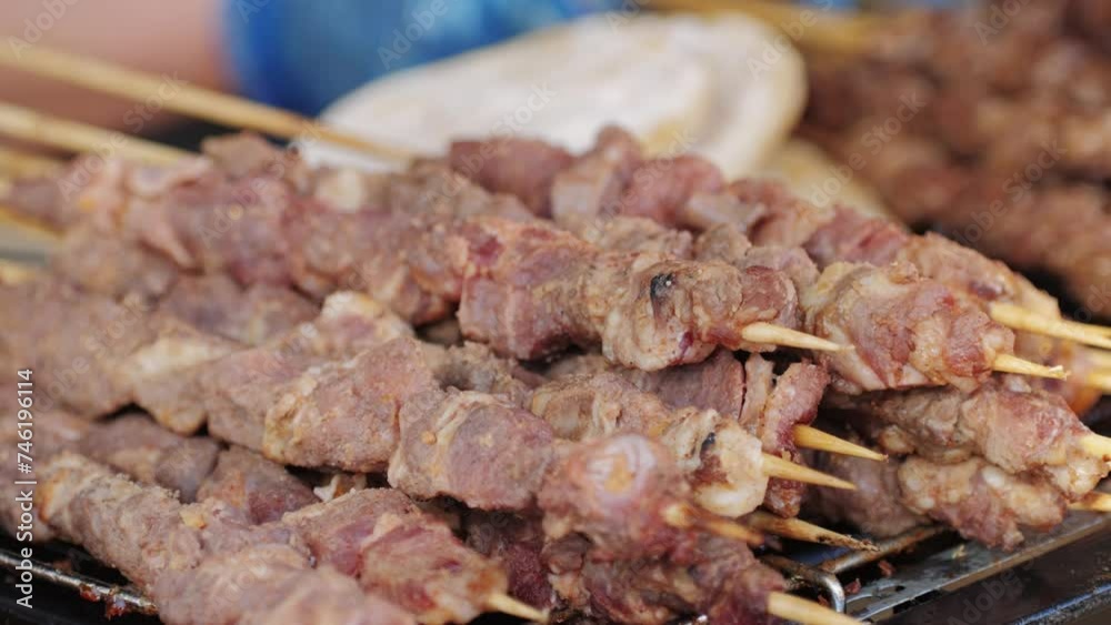 Pork meat skewer on fire, Mutton barbecue close-up. Fried meat for kebab. Cooking grilled meat beef chicken lamb BBQ . Kebab on grill. Chinese street local market with traditional food Pork meat skewer on fire, Mutton barbecue close-up. Fried meat for kebab. Cooking grilled meat beef chicken lamb BBQ . Kebab on grill. Chinese street local market with traditional food