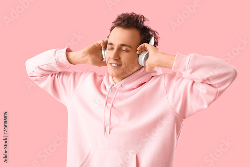 Young man in headphones lis...