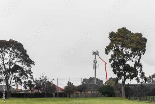 Workers Operating Crane for Telecommunication Tower Maintenance