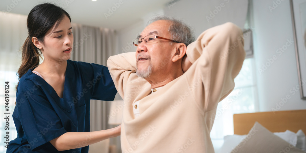 Fototapeta premium Young asian female nurse care giver helping asian senior old man in living area of nursing home senior daycare center, Nurse take care elderly patient with cheerful concentrate, health insurance