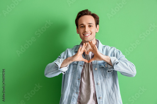 Young man making heart gest...