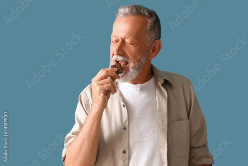 Mature man eating tasty cho...