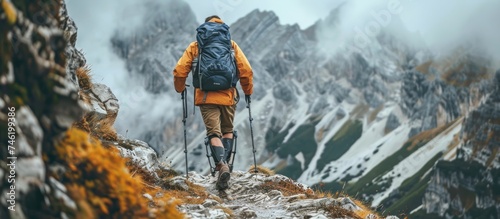 Disabled man with prosthetic legs hiking in the mountain