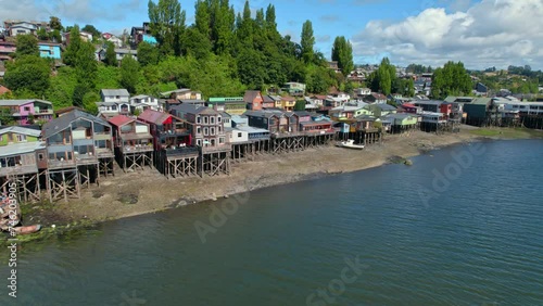 Colorful delta wooden Houses above island sea water in chilean patagonia, Neighborhood aerial drone landscape, skyline in summer photo