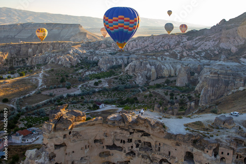 Breathtaking hot air balloon flight at dawn over unique rocky landscapes, perfect for adventure travel content, awe-inspiring posters, or inspirational blog imagery.