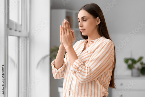 Young woman meditating with...