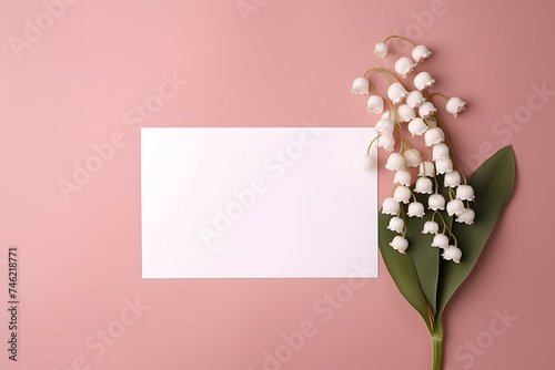 Bouquet of lilly of the valley in the left corner with empty space flat lay with pink background
