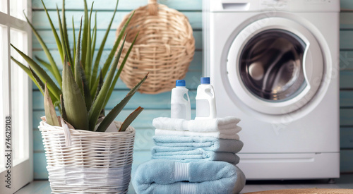 Laundry room with stacked towels, detergent, and a washing machine.