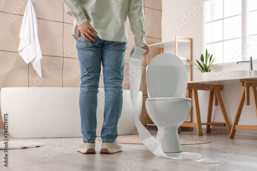 Young man with toilet paper...