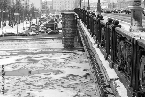 Ice drift on the winter Moscow River under the Bolshoi Kamenny bridge on the Kremlin embankment. Black and white. photo