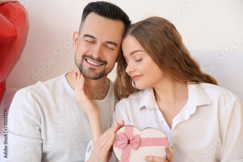 Young couple with gift box ...