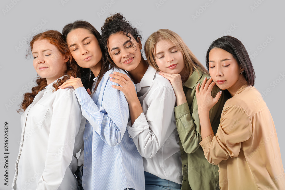 Beautiful young happy women on grey background. Women history month Beautiful young happy women on grey background. Women history month