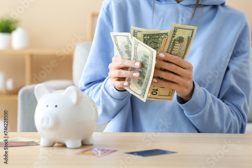Woman with piggy bank and c...