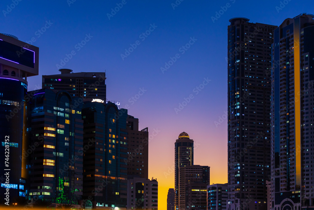 Night landscape with views of the modern skyscrapers Sharjah at sunset. United Arab Emirates.