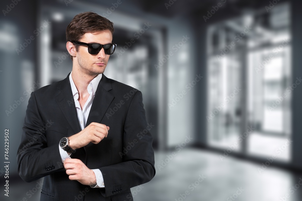 Headshot of confident male businessman on office background.