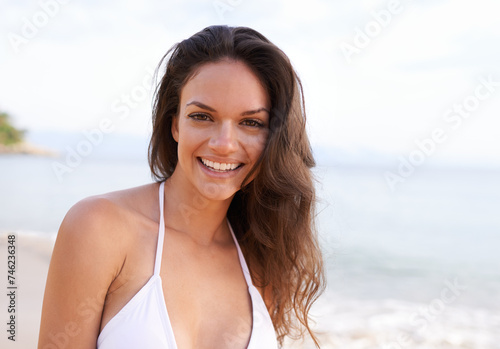 Beach, nature and portrait of woman for travel on tropical vacation, adventure or holiday. Happy, smile and female person with positive attitude by ocean on outdoor summer weekend trip by island.