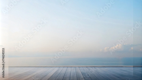 Empty room with wooden floor overlooking a tranquil beach at sunset