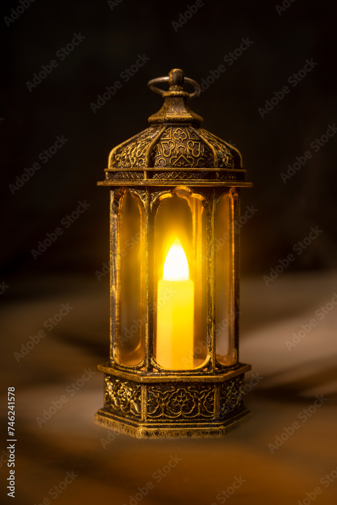 Ornamental Arabic lantern with burning candle glowing Ornamental Arabic lantern with burning candle glowing